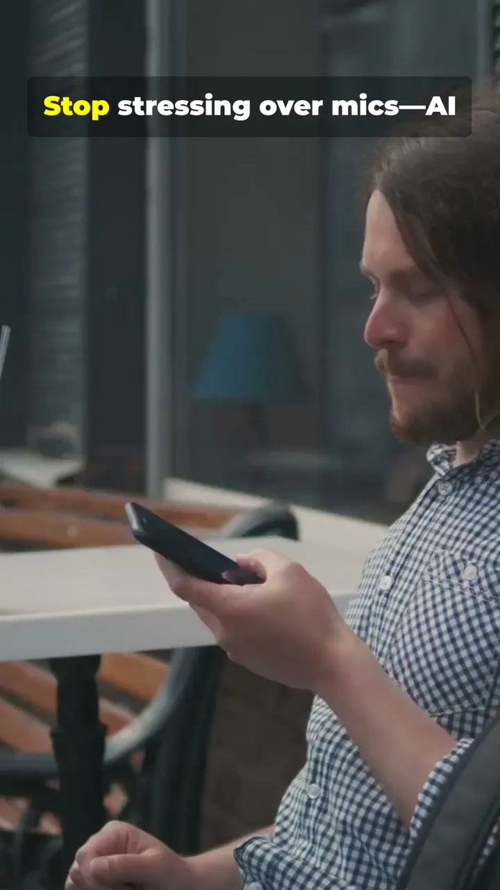 A frame from InVideo's stock-footage output: a man checking his phone at an outdoor table, with the bold yellow-and-white caption "Stop stressing over mics—AI" timed to the AI voiceover